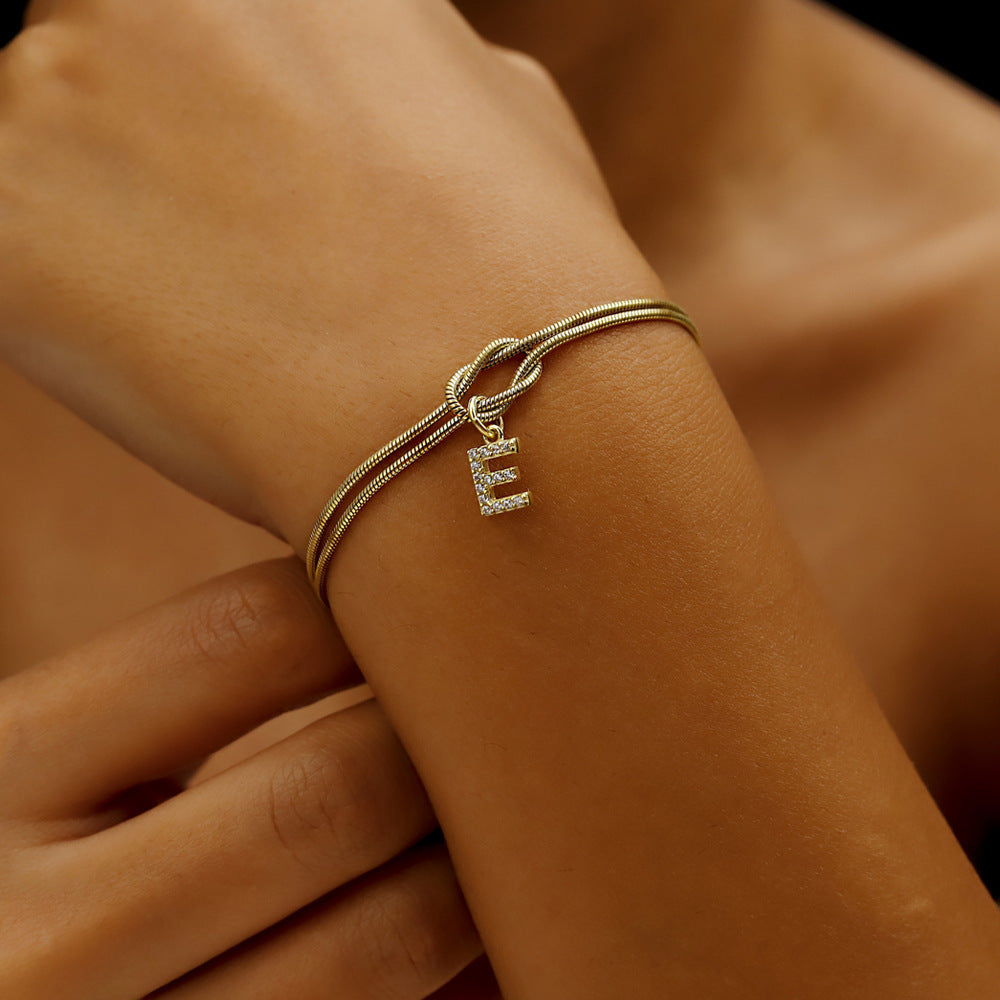 Braided bracelet with zirconia alphabet letters